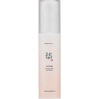 "White cylindrical bottle of Beauty of Joseon Ginseng Moist Sun Serum SPF50+ with clear cap and elegant black text"