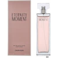 Clear glass bottle with pink liquid, rectangular shape, silver spray top, next to pink box labeled "Eternity Moment."