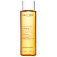Clarins Hydrating Toning Lotion 200ml in a clear amber bottle with white cap and red text.