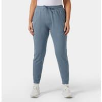 Navy knit joggers with elastic waistband, drawstring, and tapered legs, worn by a model, Helly Hansen Women's Tyri XL.