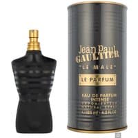 Black torso-shaped bottle with gold cap, next to cylindrical gold and black box, "Jean Paul Gaultier Le Male Le Parfum."