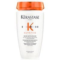 White Kérastase shampoo bottle with orange cap, Nutritive Bain Satin Riche label, and bold orange "K" logo.