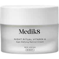 White jar of Medik8 Intelligent Retinol Smoothing Night Cream with silver lid and black text.