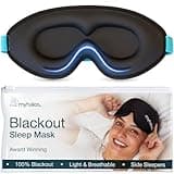 Black MyHalos sleep mask with blue trim, contoured eye cups, and adjustable strap, includes branded storage pouch.