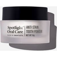 Spotlight Oral Care Anti-Stain Tooth Powder 15g in a frosted jar with black lid and bold black text.