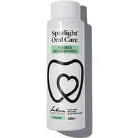 Spotlight Oral Care Whitening Mouthwash 500ml, white bottle with black tooth logo and green label accents.