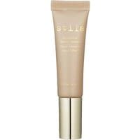 Tan Stila Aqua Glow Serum Concealer in beige tube with gold cap and white text.