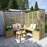 Modular wooden garden seating set with slatted panels, corner bench, cushions, and small table, surrounded by planters.