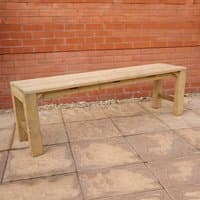 Forest wooden garden dining bench, natural finish, rectangular with sturdy legs, set on a stone patio against a brick wall.