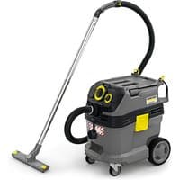 Gray Kärcher vacuum system with black hose, yellow accents, and wheeled base.