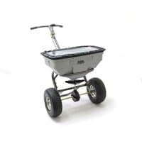 Gray Handy push broadcast spreader with black handle, large hopper, and sturdy pneumatic wheels.