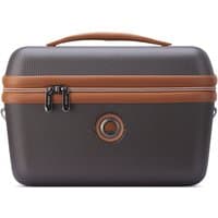Dark brown Delsey beauty case with textured finish, tan accents, top handle, and dual zippers.