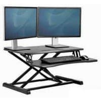 Black Fellowes Corsivo sit-stand desk converter with dual monitor setup, keyboard, and mouse on adjustable platform.