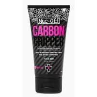 Black Muc-Off Carbon Gripper tube, 75g, with pink and white text, textured carbon fiber design, and flip-top cap.