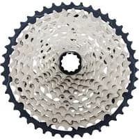 Shimano CS-M7100 SLX 12-speed MTB cassette, silver and black, 10-45T gear range, intricate gear pattern.