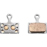 Shimano K04S disc brake pads with steel backing, metal sintered surface, and two circular holes on one pad.