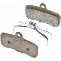 Shimano Saint M810 metal disc brake pads, brown with silver backing plate and metal spring clip.
