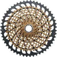 Gold SRAM Eagle XG-1299 12-speed cassette with black outer ring, intricate gear design, and 10-52 tooth range.