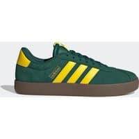 Green Adidas men's walking trainers with yellow stripes and a brown sole.