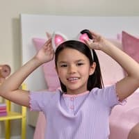 White headband with pink cat ears, worn by a child, from Gabby's Dollhouse Meow-mazing Interactive Ears Headband The Movie.