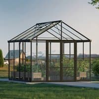 Black polycarbonate greenhouse with clear panels, peaked roof, and metal frame, set on a concrete base.