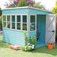 Teal wooden garden potting shed with five windows, open door, and gardening tools inside.