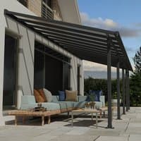 Grey Palram Canopia patio cover with clear panels, attached to house, featuring sleek metal frame and modern design.