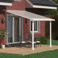 White Palram Canopia patio cover with clear panels, supported by white posts over a wooden deck.