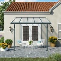 Grey Palram Canopia Sierra patio cover with clear roof panels and metal frame over a stone patio.