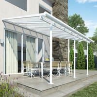White Palram Canopia Sierra patio cover with clear panels and sturdy frame over outdoor seating area.