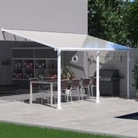 White patio cover with clear panels, supported by white posts, covering outdoor dining area.