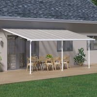 White 10x20 Palram Canopia Sierra patio cover with clear roof panels and white frame over outdoor dining area.