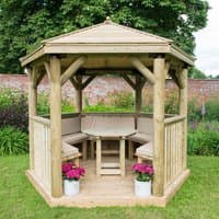 Luxury wooden garden gazebo with traditional timber roof, hexagonal shape, and seating for 10 on grassy lawn.