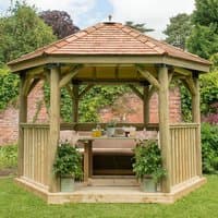Luxury wooden garden gazebo with New England cedar roof, furnished interior, and seating for up to 10 people.
