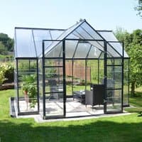 Clear-paneled greenhouse with black aluminum frame, gabled roof, and double doors, featuring spacious interior.
