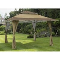 Brown 13' x 13' pop-up gazebo with peaked roof, supported by four draped legs, set on a green lawn.