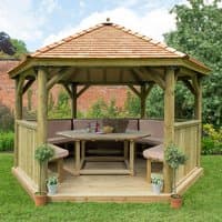 Luxury wooden garden gazebo with New England cedar roof, seats 15, features benches and central table, set on grass.