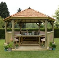 Luxury wooden garden gazebo with New England cedar roof, seating for 19, surrounded by greenery.