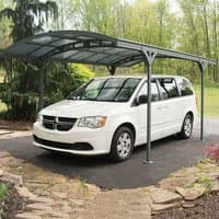 Grey Palram Canopia carport with arched roof and sturdy metal frame, covering a white van on a paved driveway.