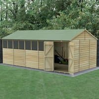 Wooden shiplap shed with green roof, double doors, reverse apex design, and multiple windows on one side.