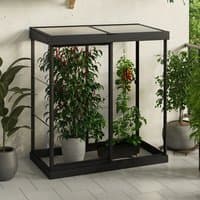 Black Palram Canopia mini greenhouse with clear polycarbonate panels and a compact 4' x 2' frame, housing plants.