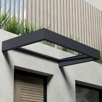 Grey Palram Canopia door canopy with clear panel, rectangular shape, mounted above a door on a modern building.