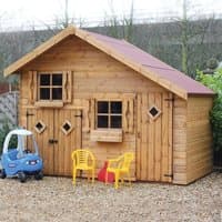 Two-storey wooden playhouse with garage, diamond windows, red roof, and two yellow chairs outside.