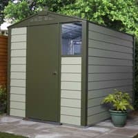 Green and beige metal shed with single door, window, and horizontal paneling, set on a patio with a potted plant.