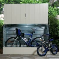 Cream Trimetals metal bike shed with vertical ridges, hinged lid, and space for storing two bicycles.