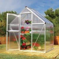 Silver Palram Canopia Mythos greenhouse with twin-wall polycarbonate panels and open door, set on wooden deck.