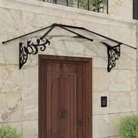 Black and clear door canopy with ornate side brackets, mounted above a wooden door on a stone wall.