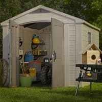Beige Keter Factor Apex Plastic Garden Shed with double doors, window, and wood-like texture, surrounded by greenery.
