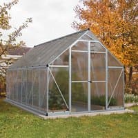 Aluminium-framed greenhouse with clear panels, pitched roof, and double door, set in a grassy garden.