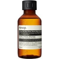 Amber Aesop body cleanser bottle with black cap and white label, 100 ml size.